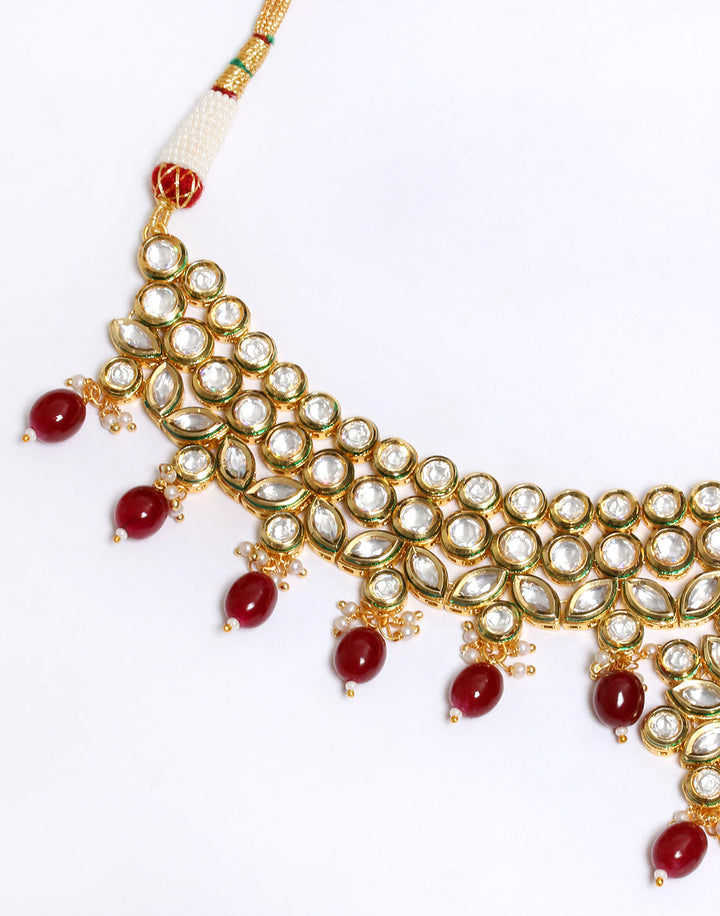 Elegant Gold Toned Kundan Set With Ruby Stone